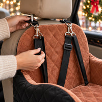 Adjustable strap with metal clip looping around the car headrest