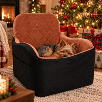 Dog car seat used as a cozy home bed by the Christmas tree with a Yorkie