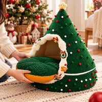 Removable round cushion being taken out of the Christmas tree cat cave