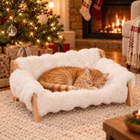 Cloud Lounger elevated pet sofa bed in Cream White with a sleeping orange cat by the Christmas tree